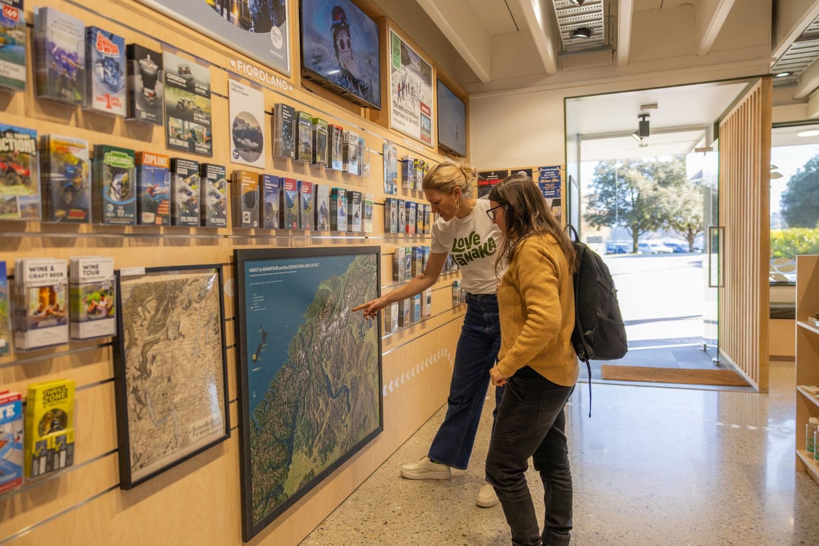 Guide pointing out a route on the wall map